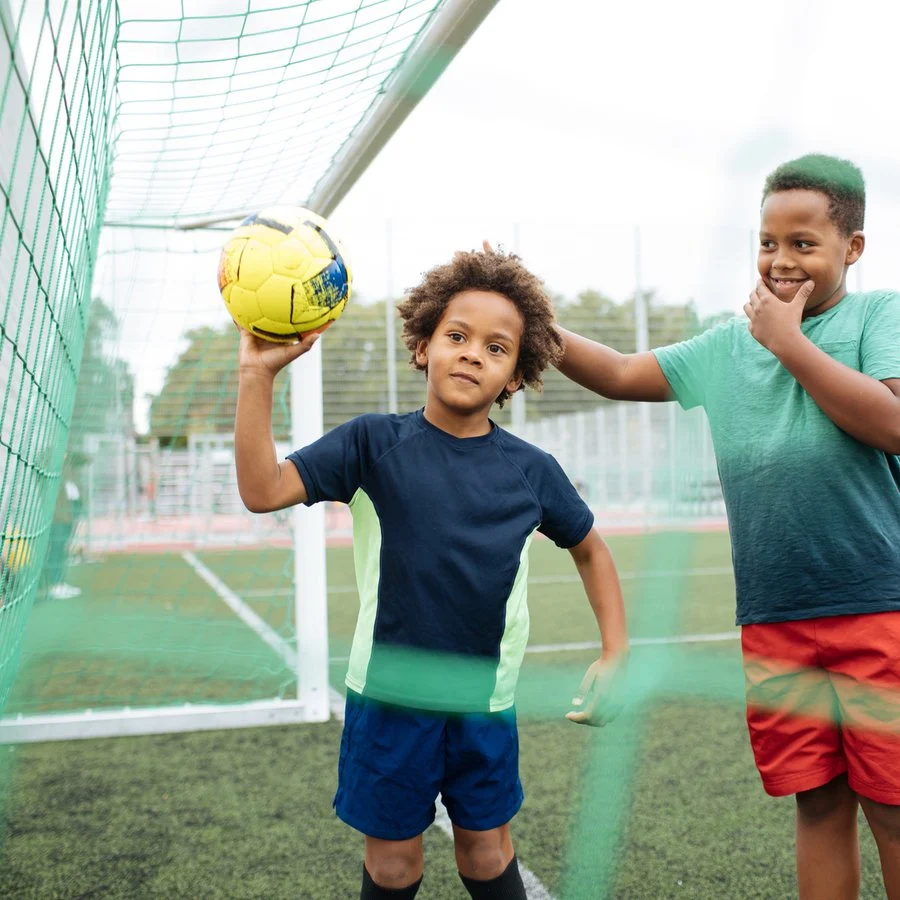 Young boy playing football outdoors