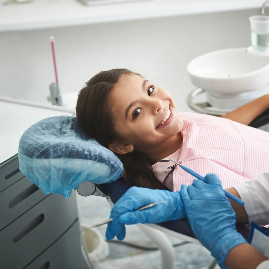Cheerful girl visiting her pediatric dentist