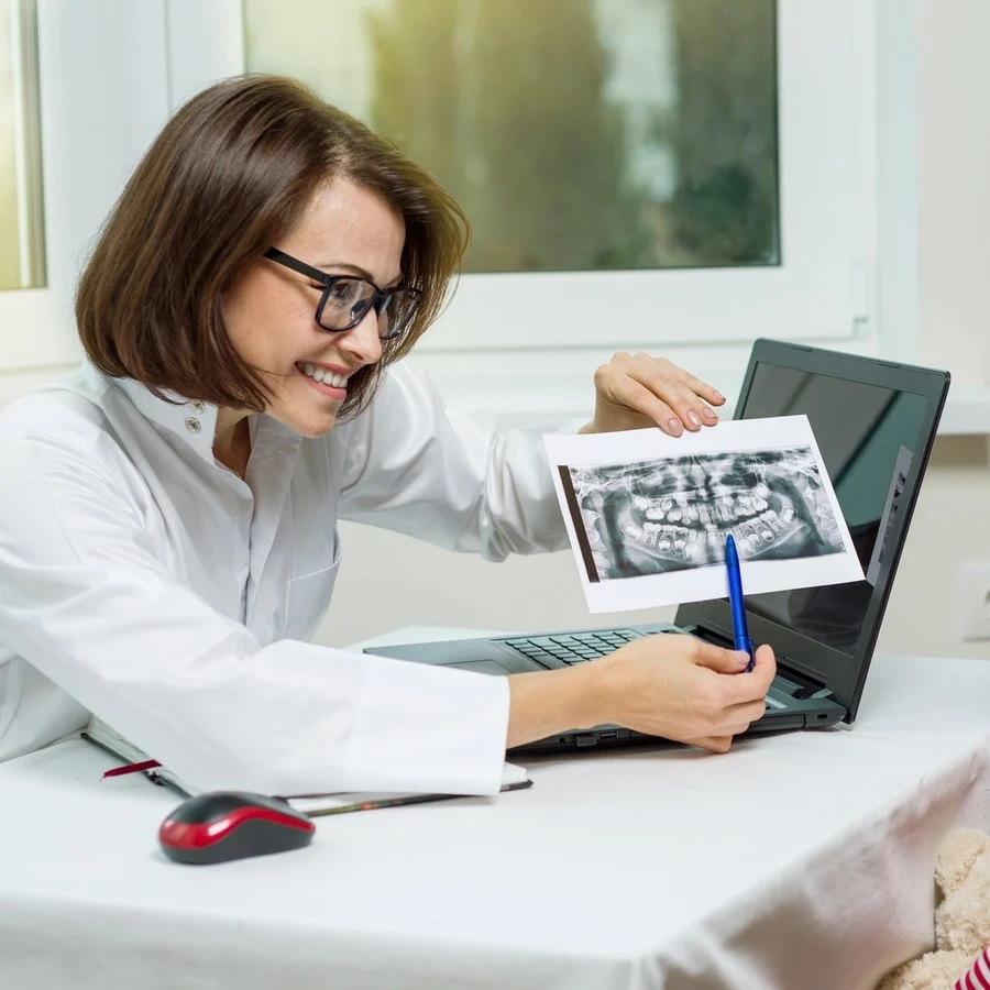 Dentist showing a digital X-ray to a patient in the office