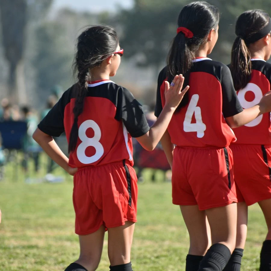 Two girls shaking hands after a youth soccer game