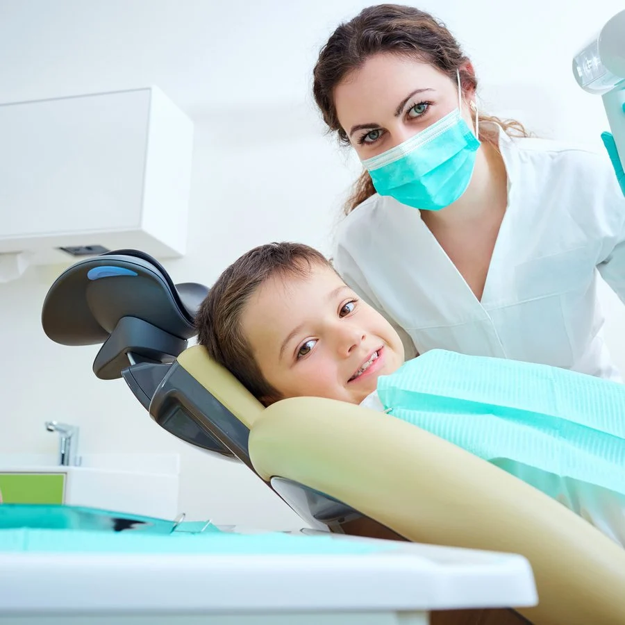 Smiling boy sitting in a dental chair during a checkup